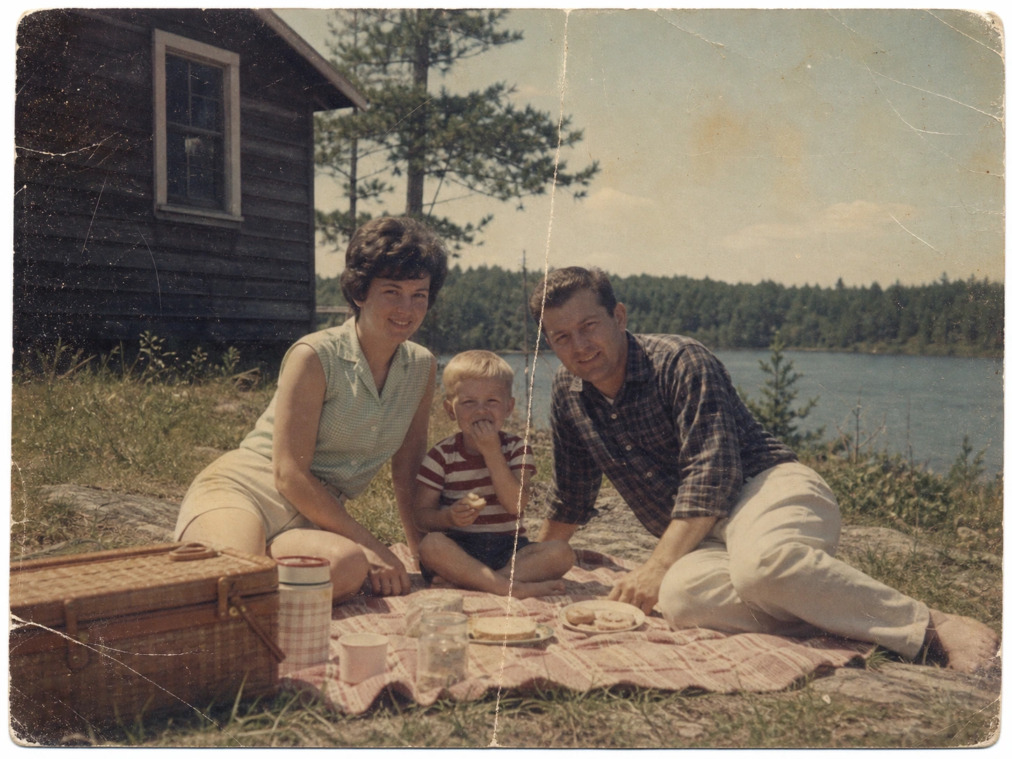 Faded and damaged lakeside picnic photograph before AI restoration